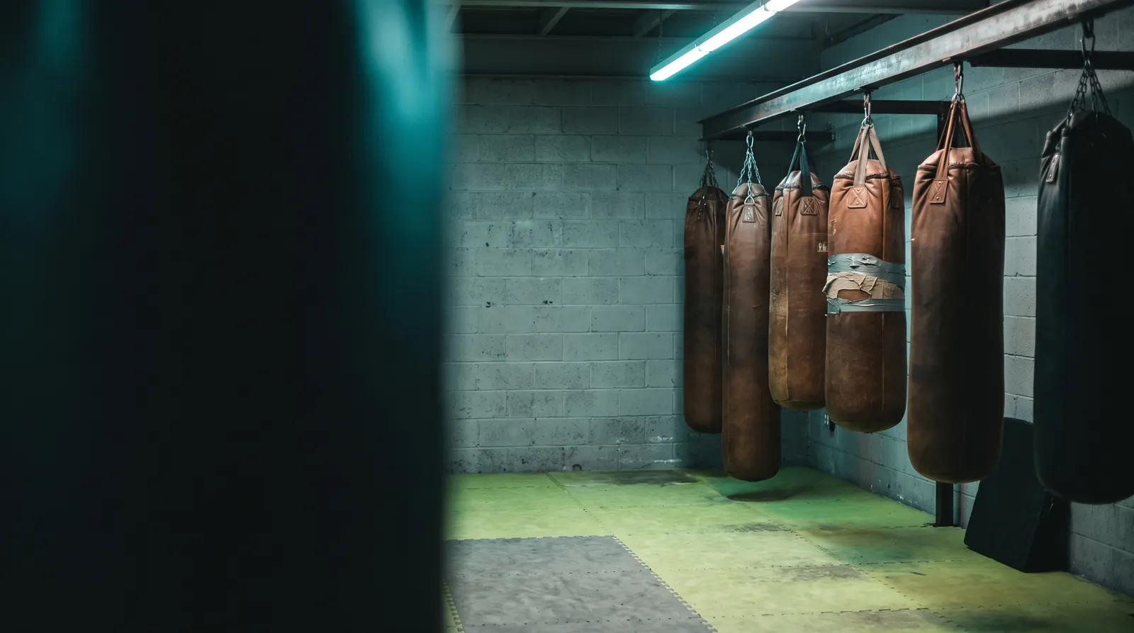 Heavy bags hanging over mat flooring